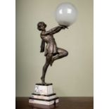 Emile Carlier of France, an Art Deco table lamp of a girl supporting a glass ball all on a stepped