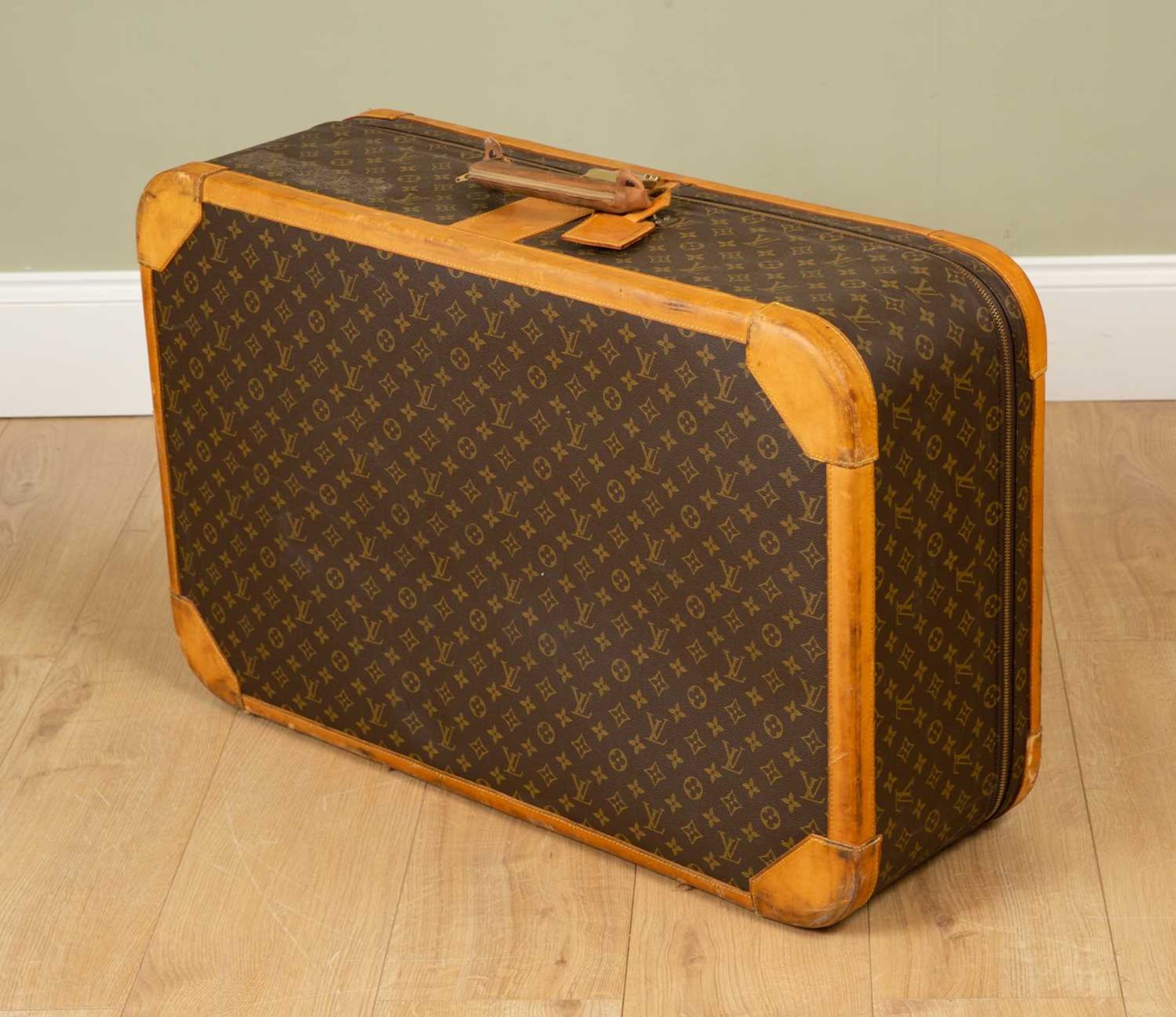 A Vintage Louis Vuitton suitcase with brass clasp and combination lock, 85cm wide x 27cm deep x 54cm