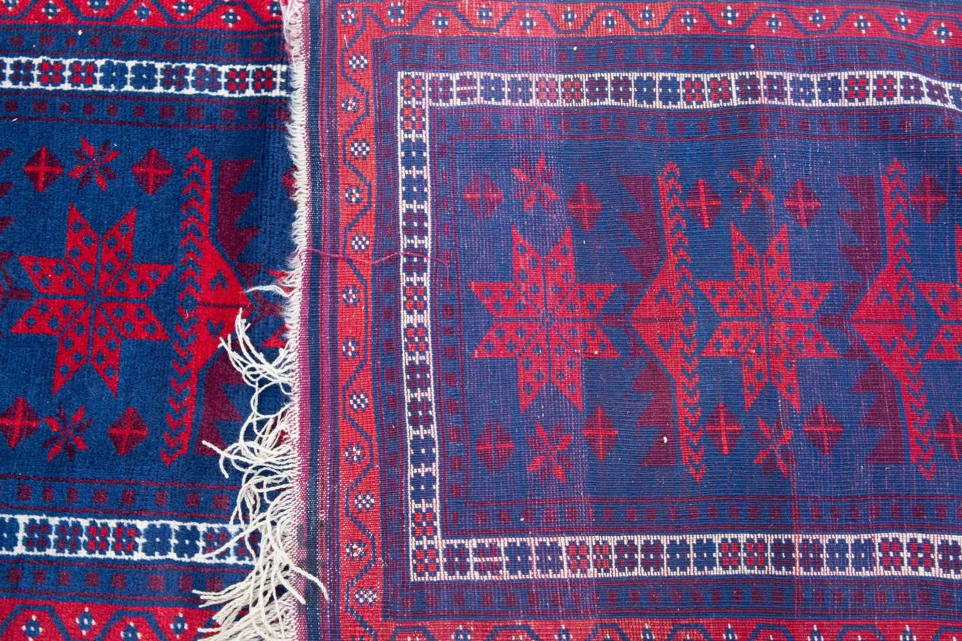 A Turkish blue ground runner with fourteen star motifs to the central field and within a triple - Image 2 of 2