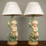 Two painted plaster table lamps in the form of putti supporting cornucopia and with pleated