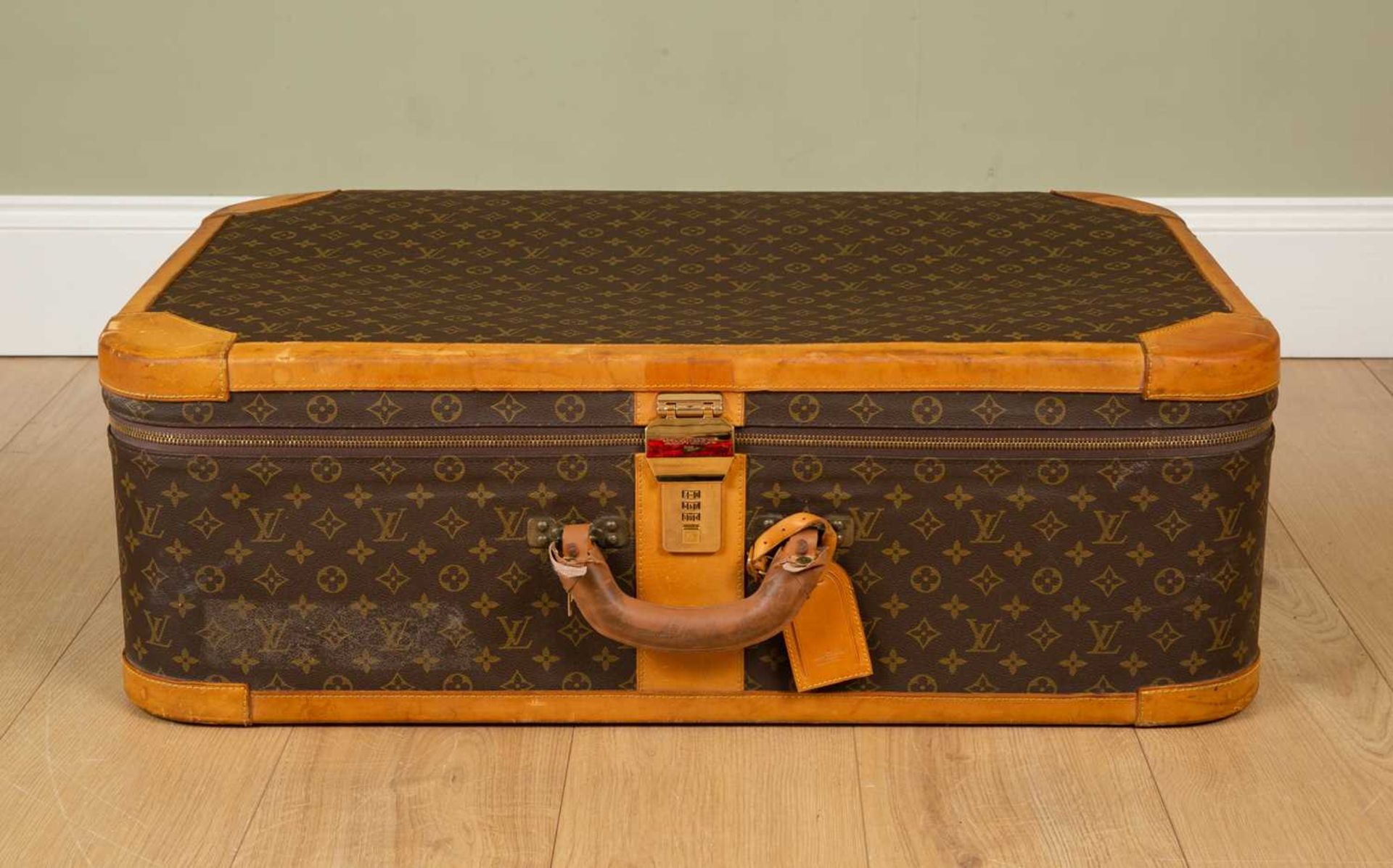 A Vintage Louis Vuitton suitcase with brass clasp and combination lock, 85cm wide x 27cm deep x 54cm - Image 2 of 8