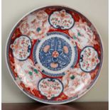 An antique Japanese porcelain charger decorated in Imari colours, 46cm diameterMinor wear to the