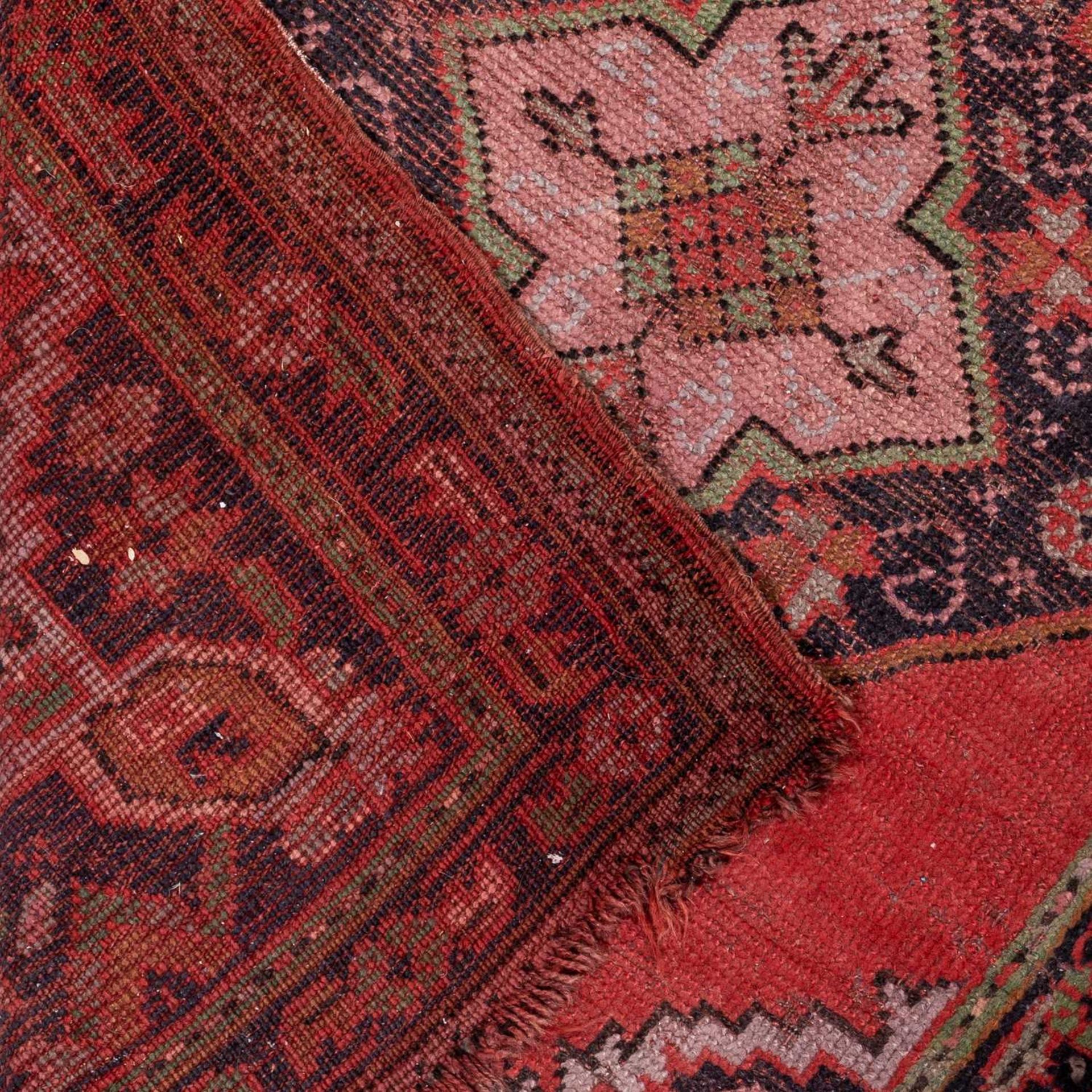 A small Turkey red ground rug together with a group of four further modern Oriental rugs (5)The - Image 6 of 11