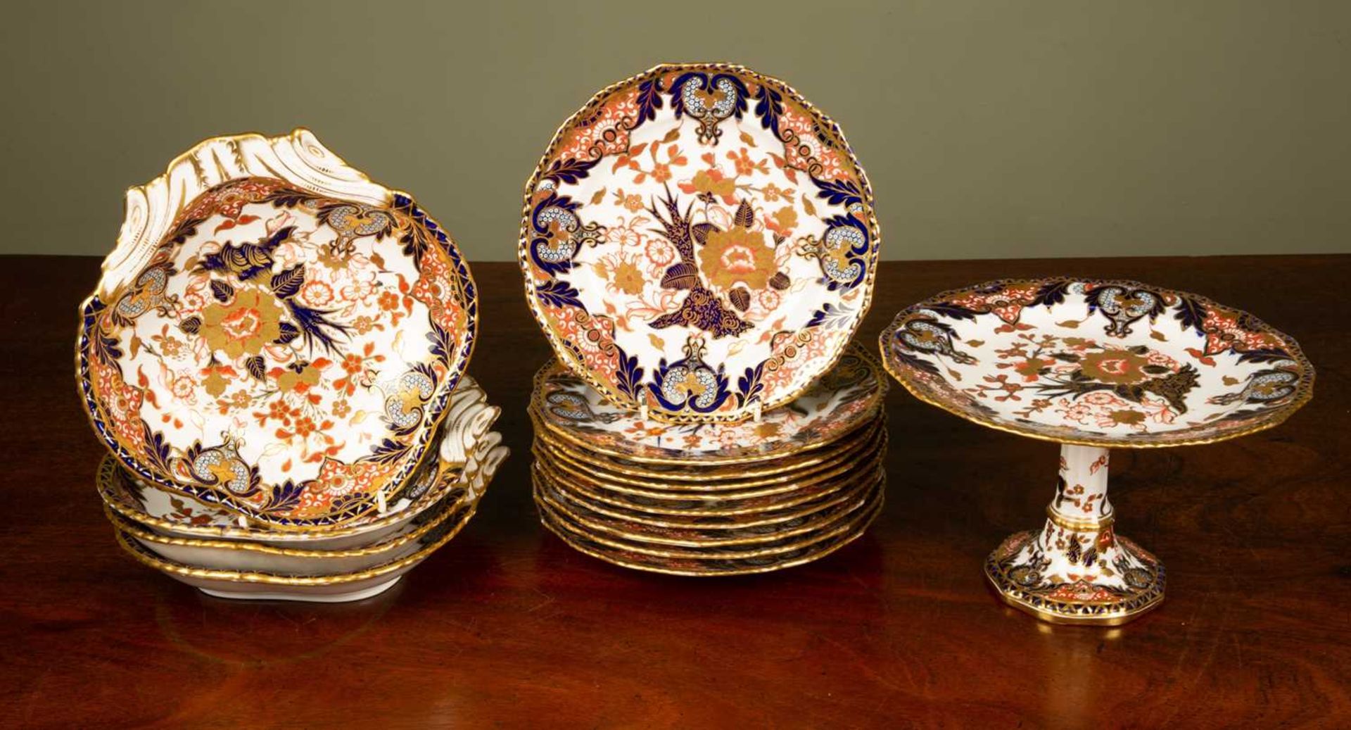 A Royal Crown Derby Imari patterned part dessert service consisting of ten plates, four shell-shaped