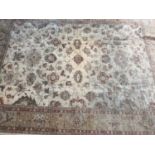 A cream ground Ziegler-style small carpet, with floral decoration within a multiple banded border,