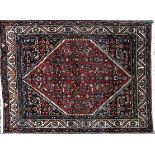 A 1920's red ground Hamadan rug, with central diamond motif, 149cm x 108cm Minor marks due to use,