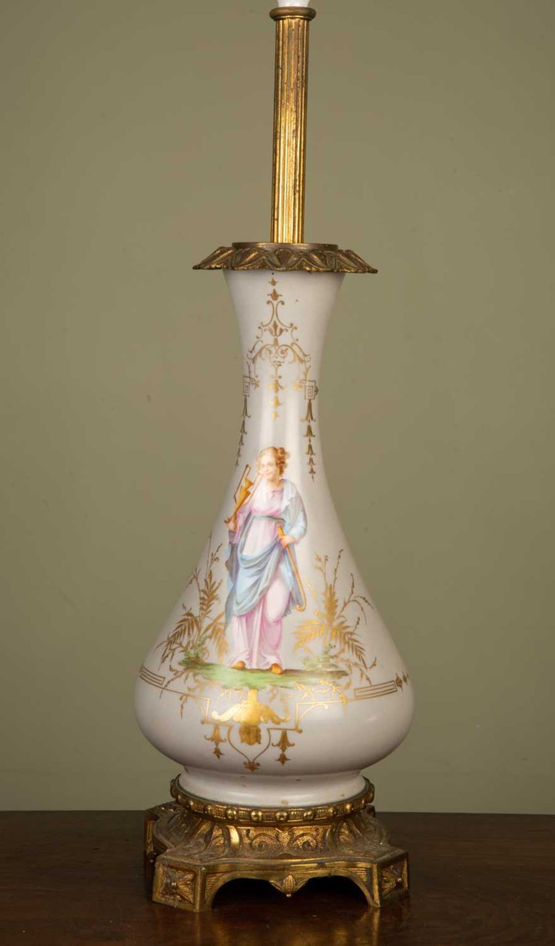 A continental porcelain oil lamp base of baluster form decorated with a classical female, in