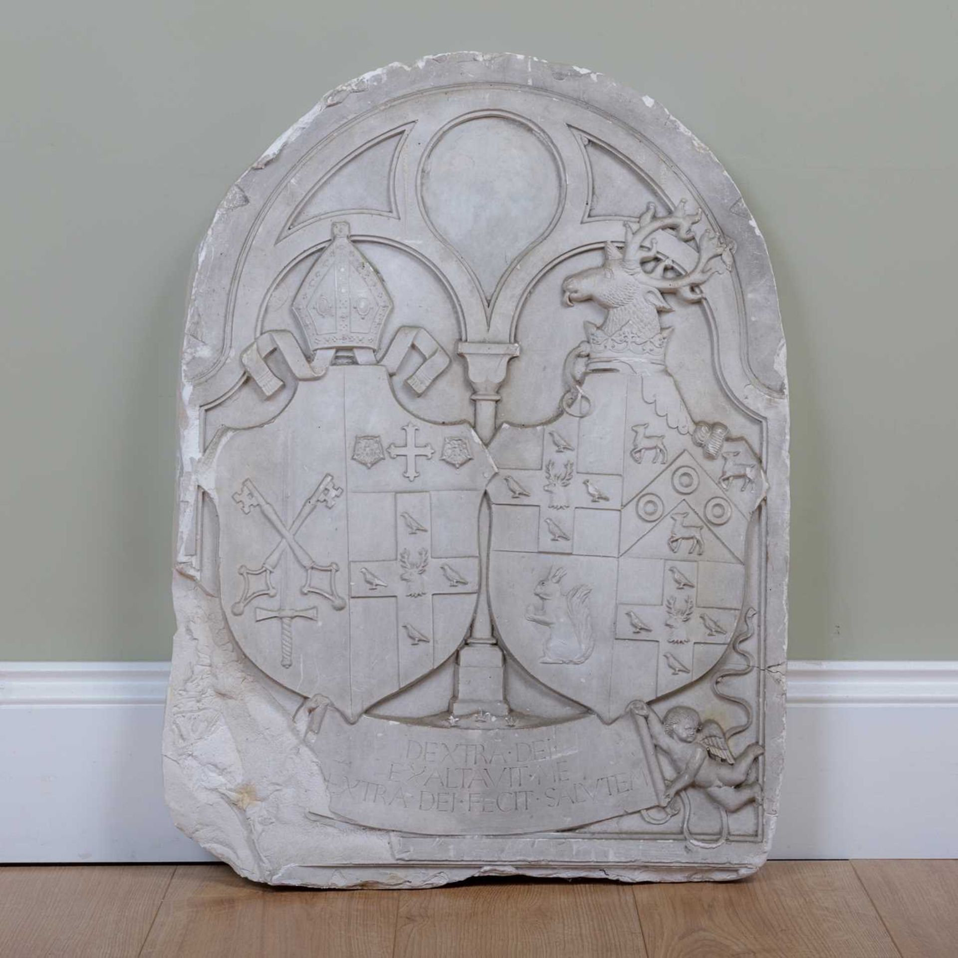 A cast plaster heraldic panel with motto beneath the heraldic shields 'Dextra dei exaltauit me extra