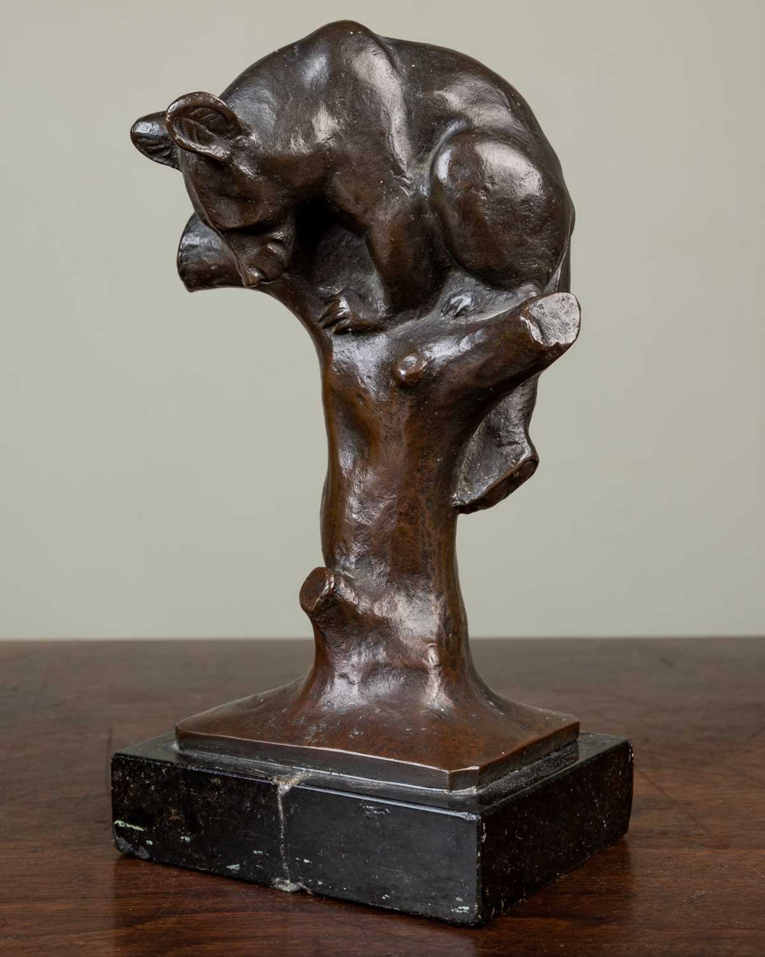 O.M. (early 20th Century German School), a young climbing bear, bronze, signed with initials 'O.