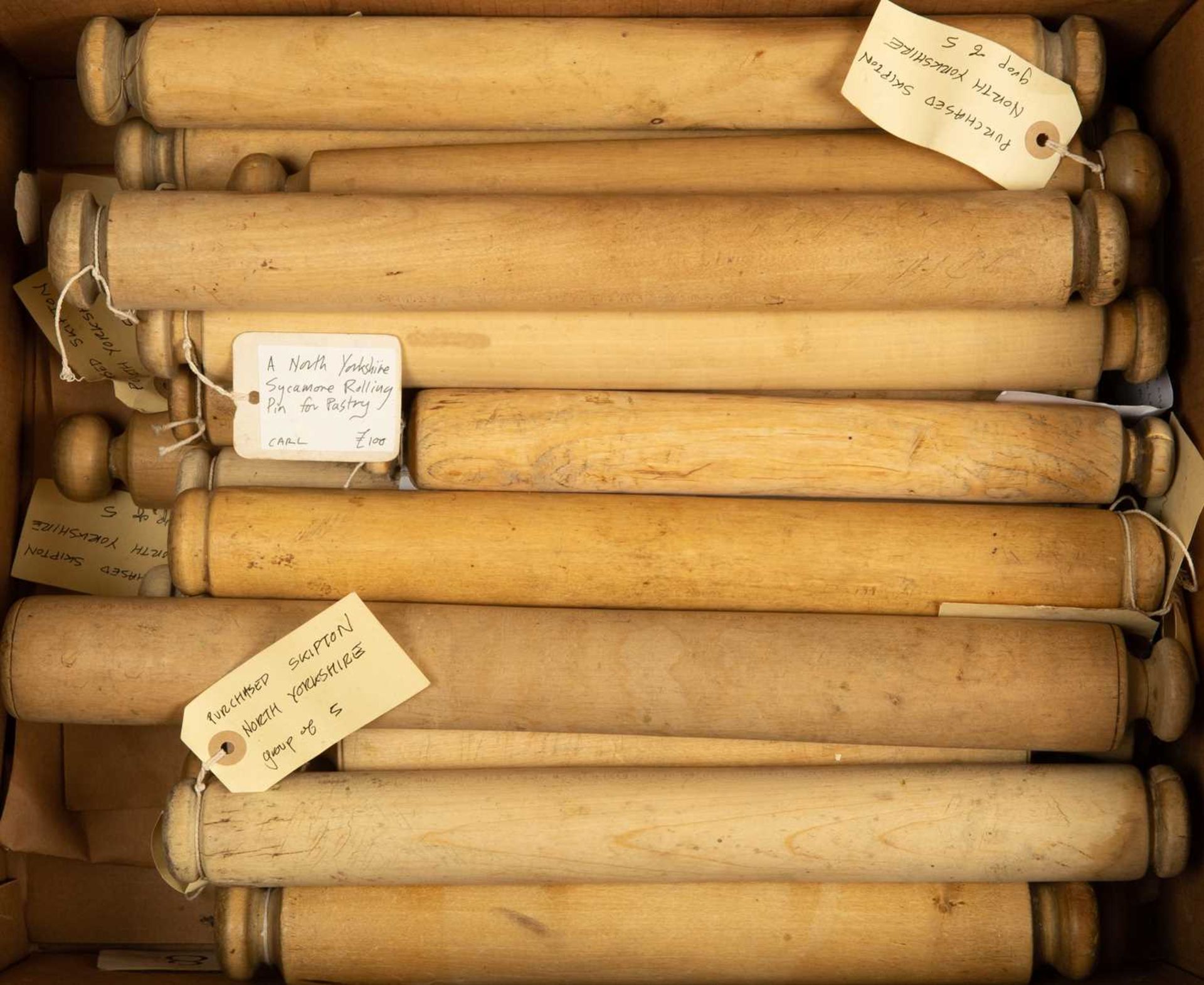 A collection of twenty three North Country sycamore rolling pins, the largest 46cm wide (23)In