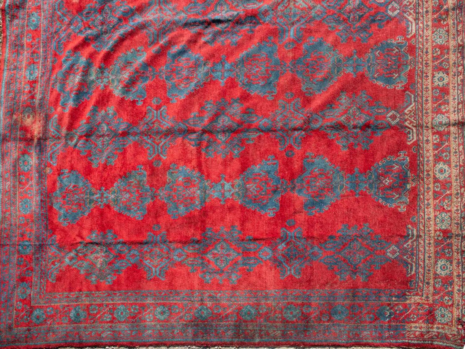 A large red ground Turkey carpet with geometric decoration, 430cm x 407cmStains, marks and minor - Image 2 of 7