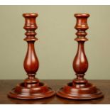 A pair of turned wooden candle sticks in the Georgian style, 24cm high (2)Minor marks, dents and