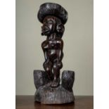 A 20th century tribal stand or stool with carved decoration of a nude female and indistinct