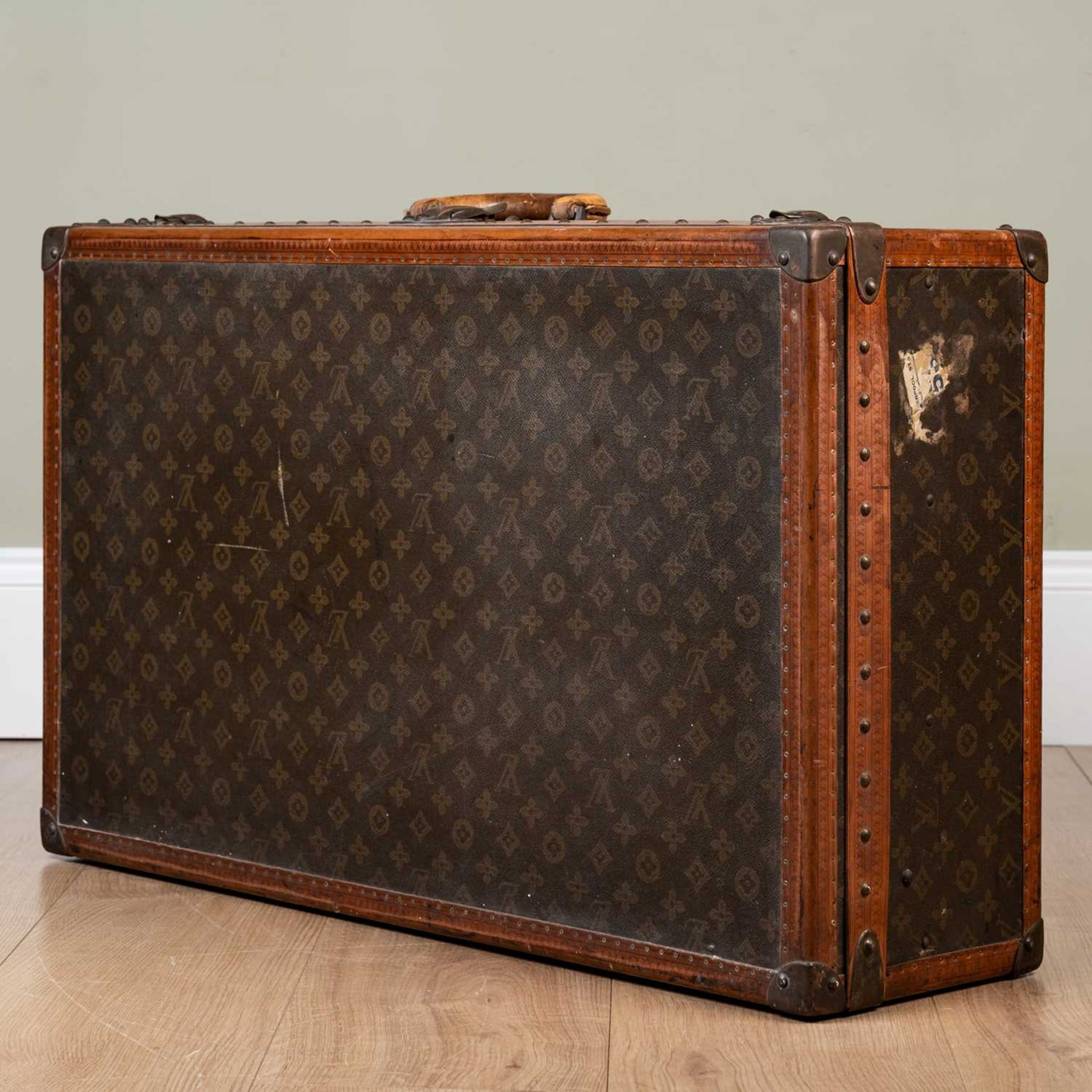 A vintage Louis Vuitton suitcase, early 20th century, with leather carrying handle, the lock - Image 2 of 11
