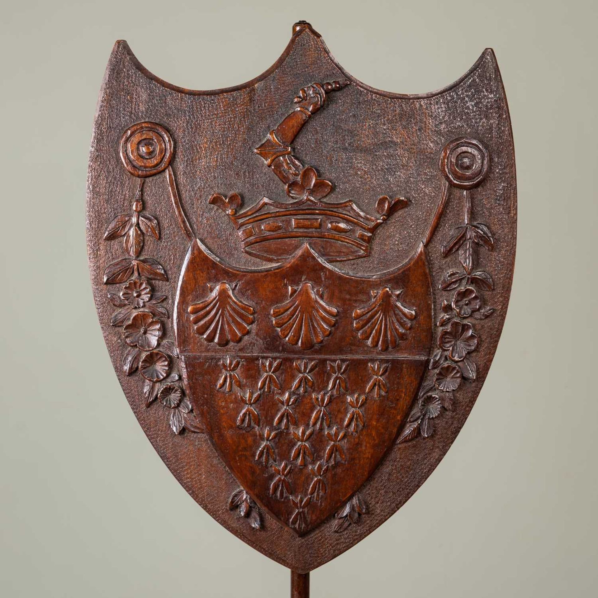 A 19th century mahogany pole screen, the shield shaped carved screen decorated with a heraldic - Image 2 of 3