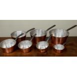 A set of graduated copper pans with tin lining, stamped Serie Spéciale Villedieu, largest measures