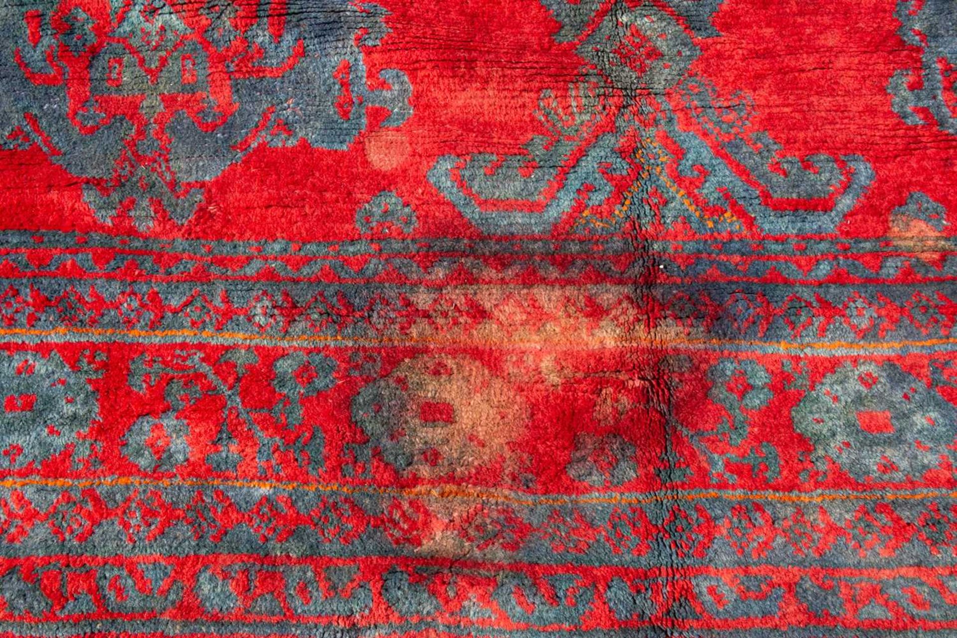 A large red ground Turkey carpet with geometric decoration, 430cm x 407cmStains, marks and minor - Image 6 of 7