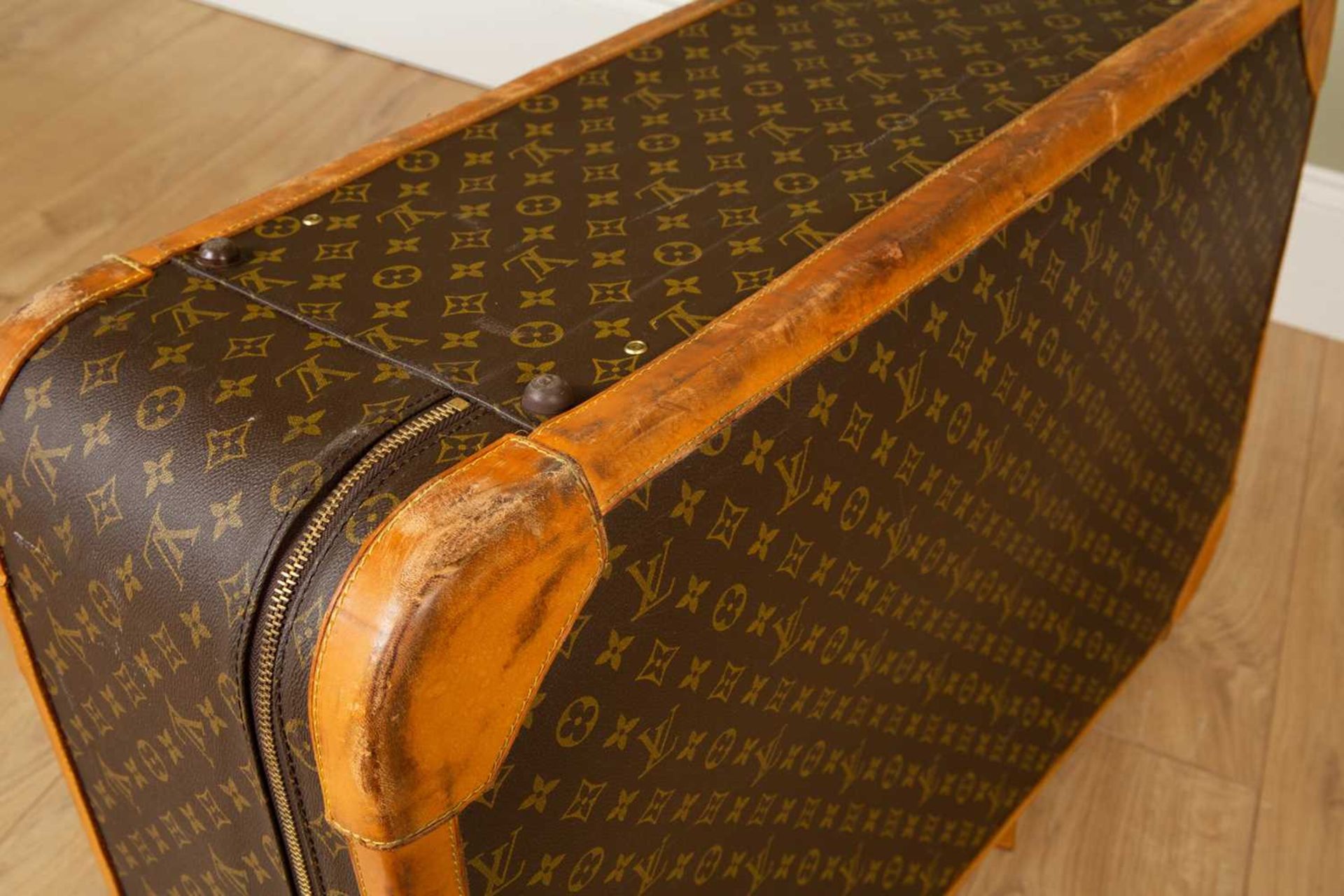 A Vintage Louis Vuitton suitcase with brass clasp and combination lock, 85cm wide x 27cm deep x 54cm - Image 5 of 8