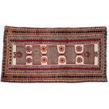 A cream ground tribal rug with five rectangular medallions within a multiple banded border, 190cm