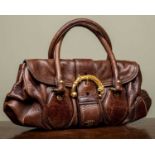 A ladies Prada Cervo dragon buckle brown leather bag with additional brown leather tags and