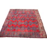 A large red ground Turkey carpet with geometric decoration, 430cm x 407cmStains, marks and minor
