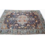 A large Middle Eastern blue ground pictorial carpet decorated with hunters chasing wild animals in