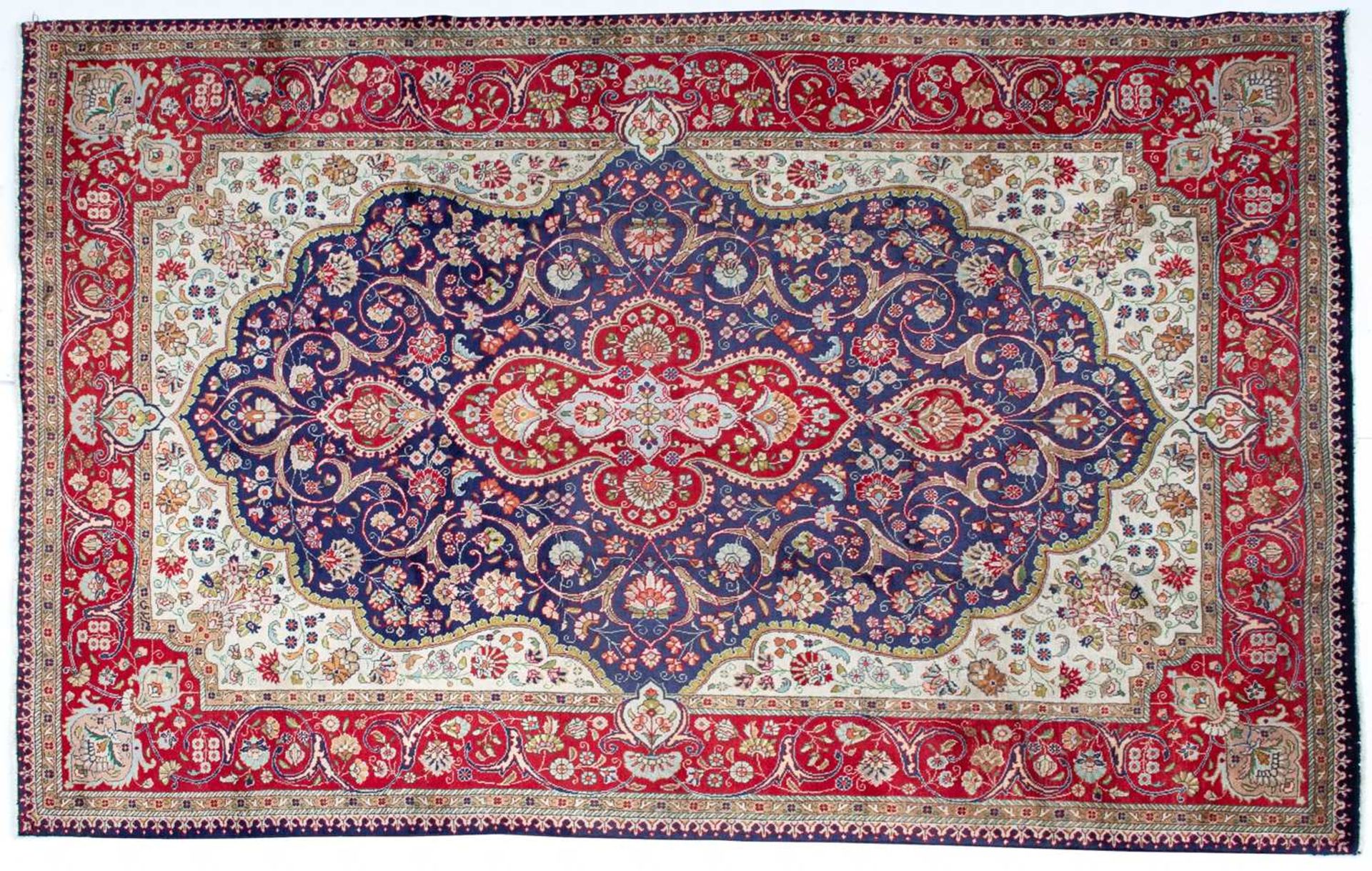 A Tabriz blue ground rug with stylised foliage, 300cm x 200cm Minor marks, otherwise good condition.