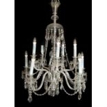 A cut glass ten-branch chandelier or electrolier with swags of drops round a central knopped stem,