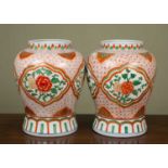 A pair of Chinese porcelain baluster vases with a diaper ground and floral cartouches, 26cm diameter