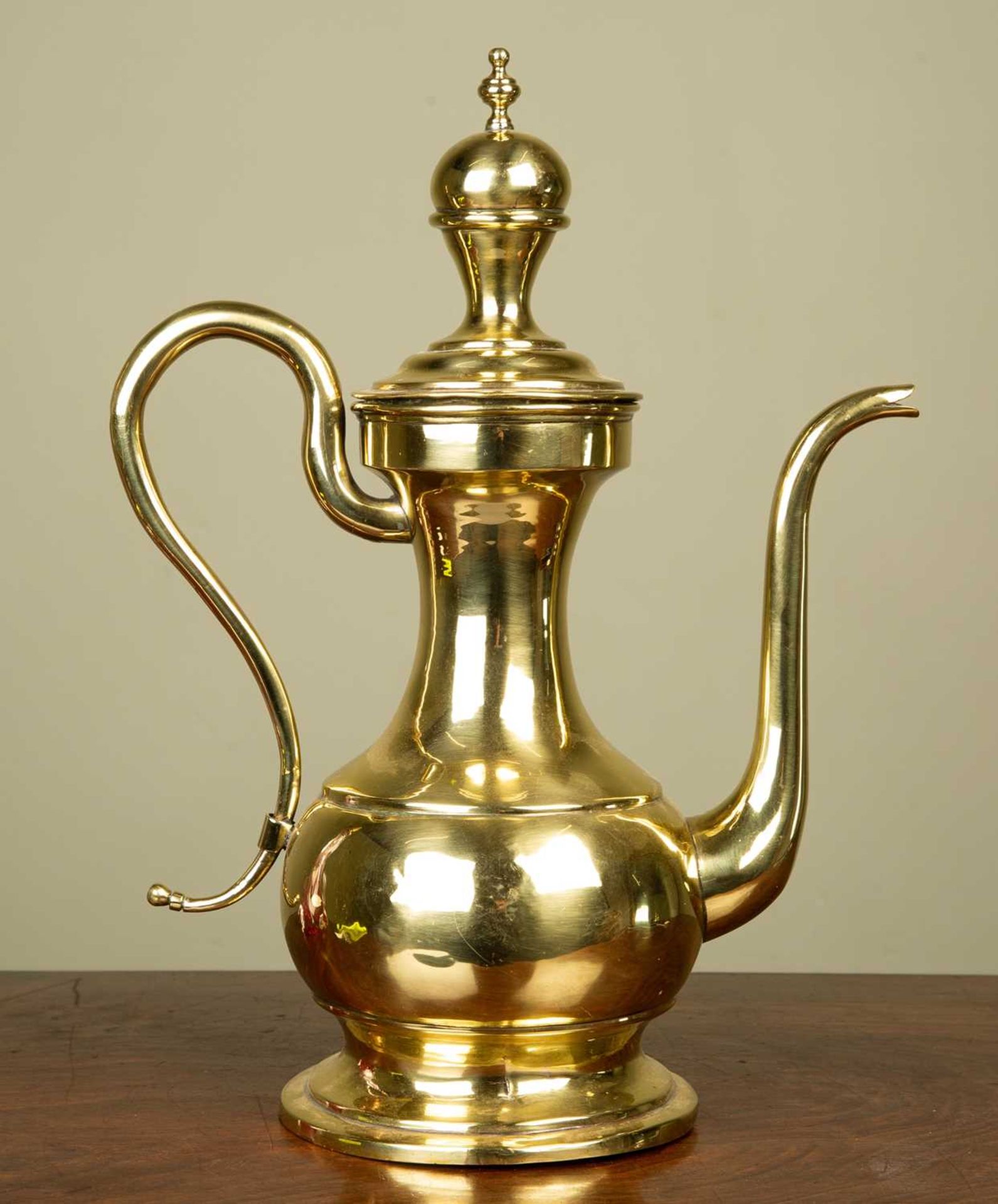 An 18th century Dutch brass coffee pot with scrolling handle, possibly Colonial, 39cm highMinor