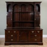An early 20th century mahogany dresser in North Country style, the plate rack with arcaded shelf