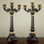 A pair of cast bronze and parcel gilt empire style four-light three-branch candelabra of classical