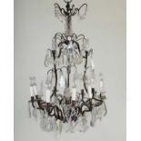 A French chandelier or electrolier with nine lights and three decorative finials between, and with