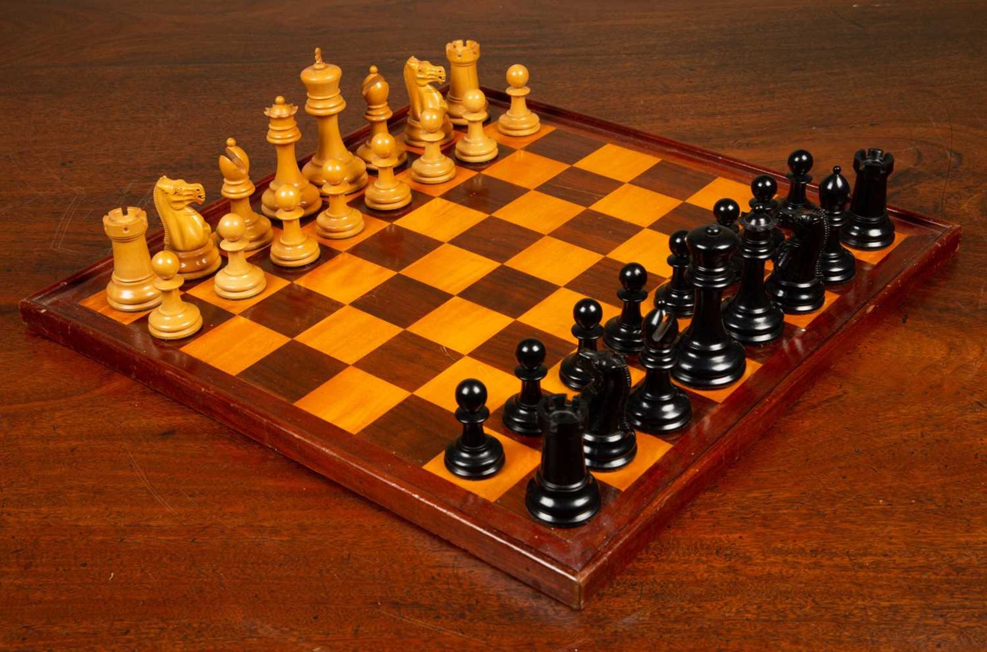 A Staunton club size chess set by Jaques of London, boxwood and ebony, together with the box and a