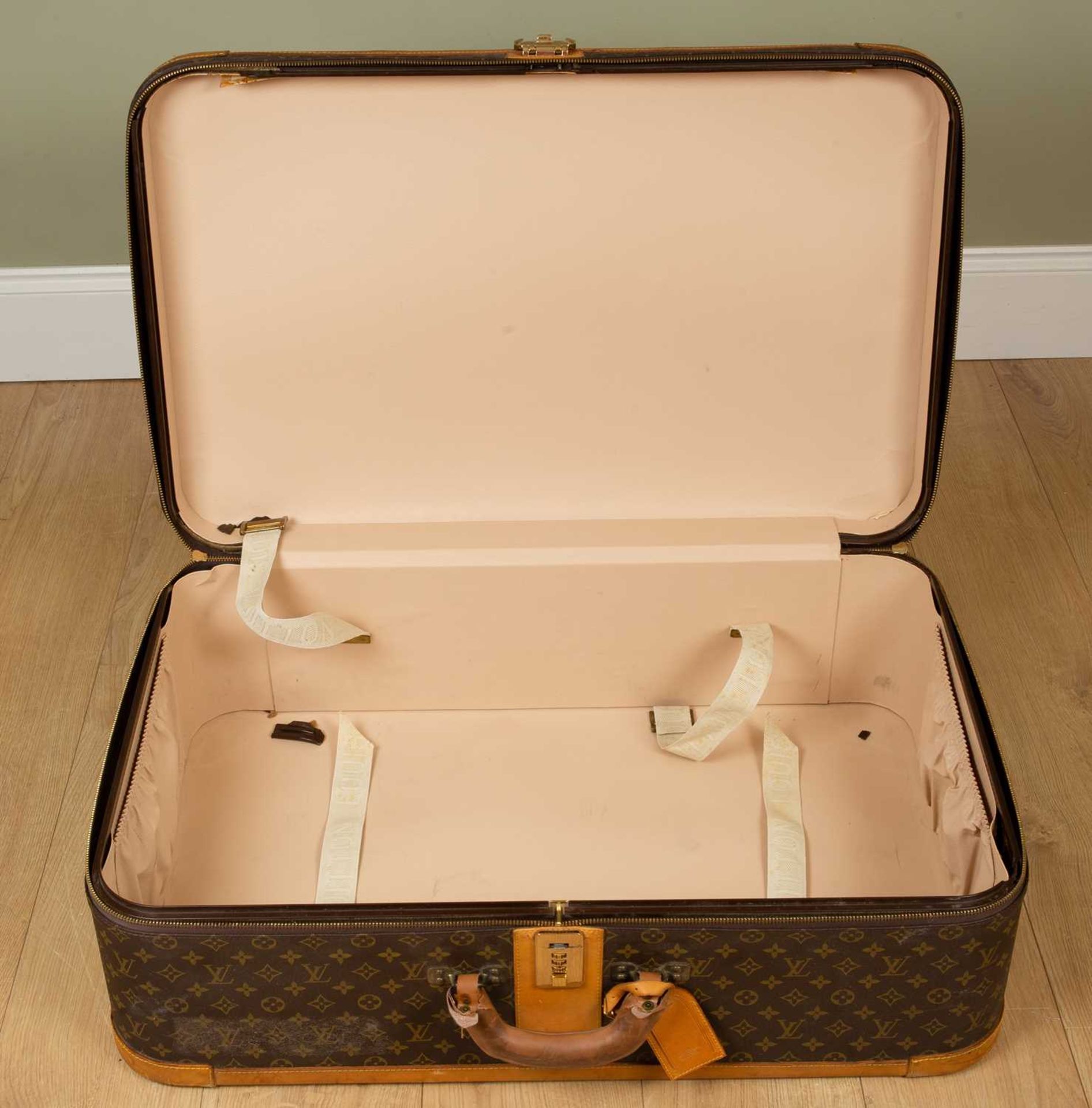 A Vintage Louis Vuitton suitcase with brass clasp and combination lock, 85cm wide x 27cm deep x 54cm - Image 7 of 8