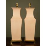 A pair of contemporary ceramic pink glazed square tapering section table lamps with gilt plinths,