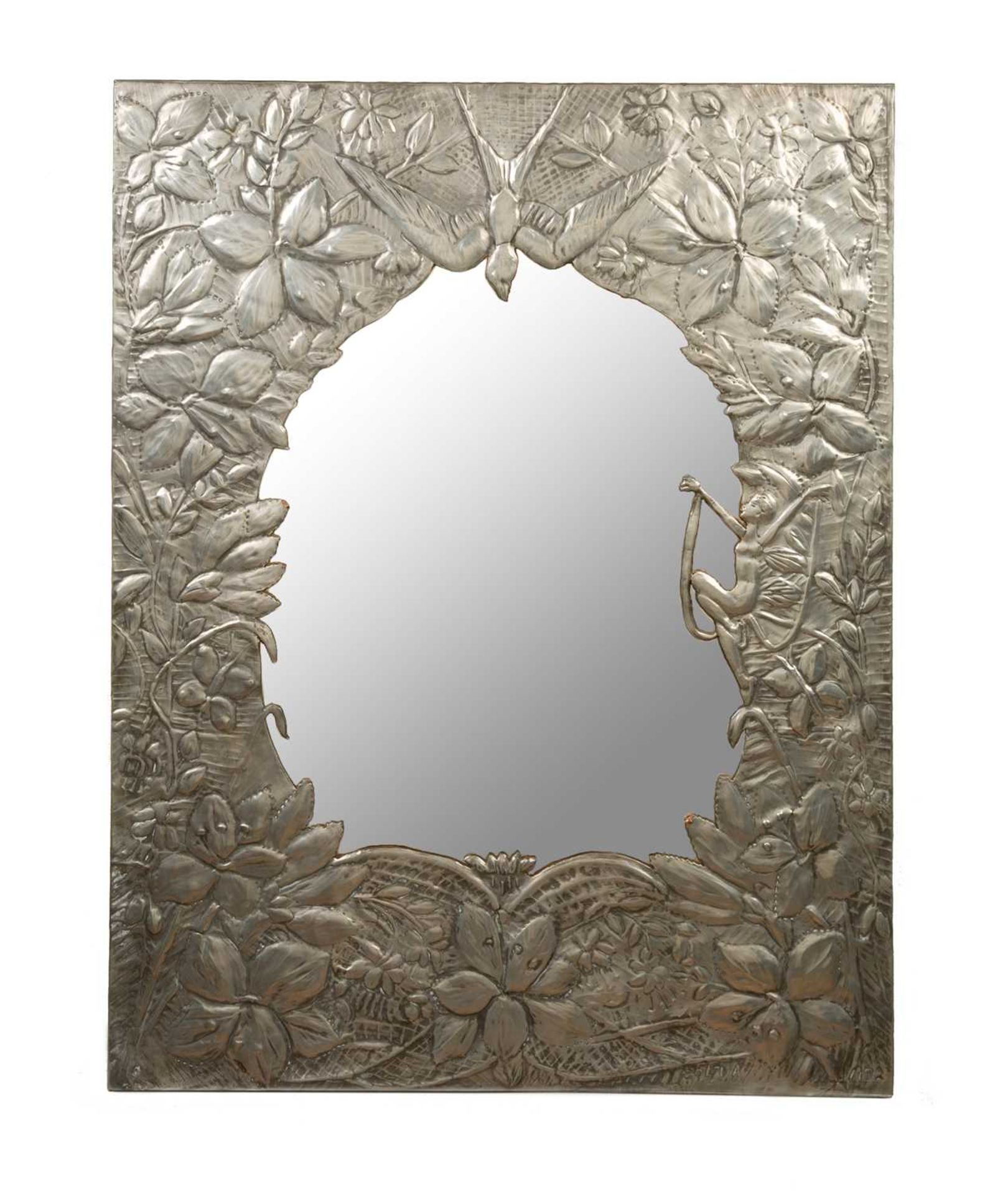 A decorative early to mid 20th century pewter framed wall mirror with chased and engraved ornament