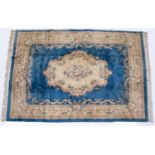 A Chinese blue ground carpet with stylized floral design and blue outer border, 367cm x 272cmFaded