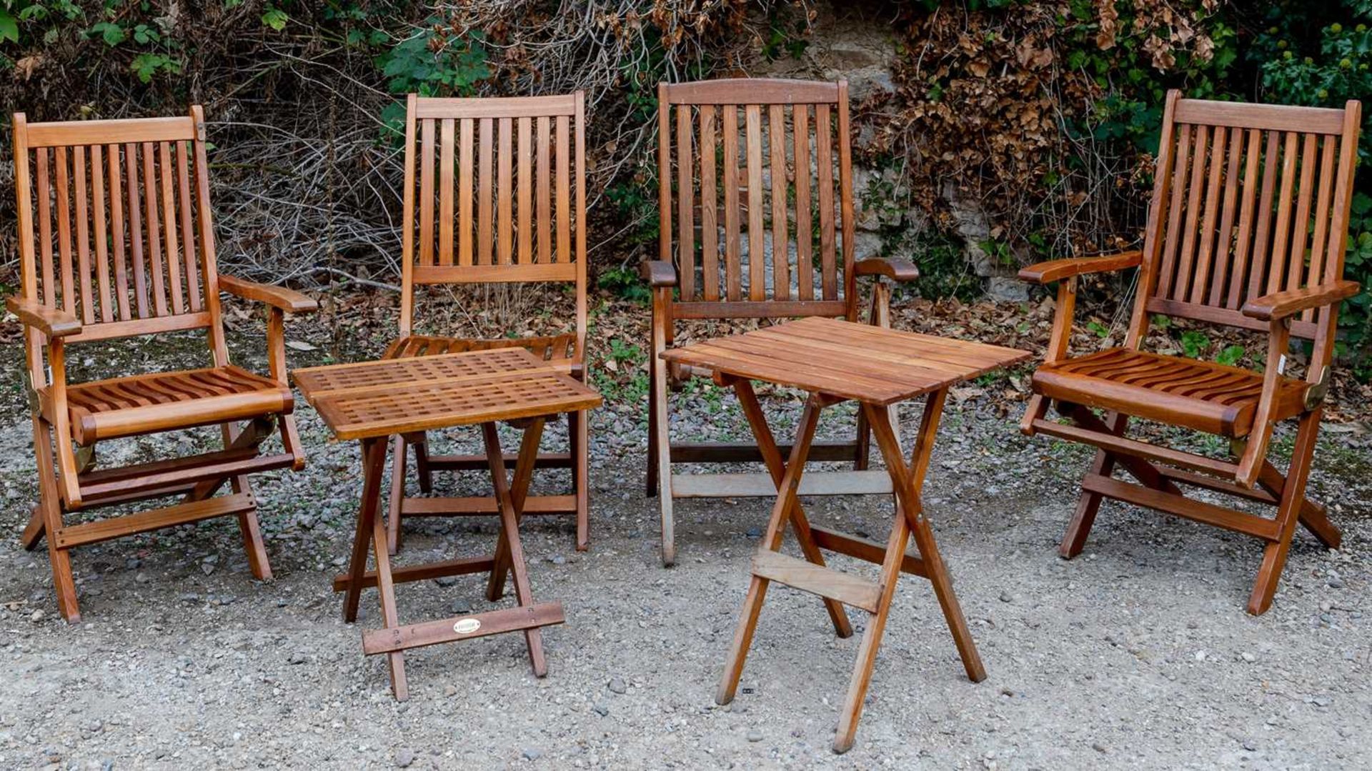 A pair of Westminster teak folding garden chairs, each 56cm wide; together with two further