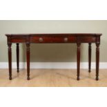 An early Victorian mahogany break front serving table with single frieze drawer and on reeded turned
