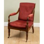 A 19th century mahogany framed library armchair with spindle turned back, overstuffed upholstered