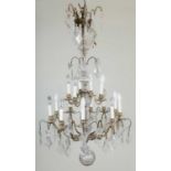 A two-tier twenty-light chandelier or electrolier with cut glass drops, central hexagonal stem and