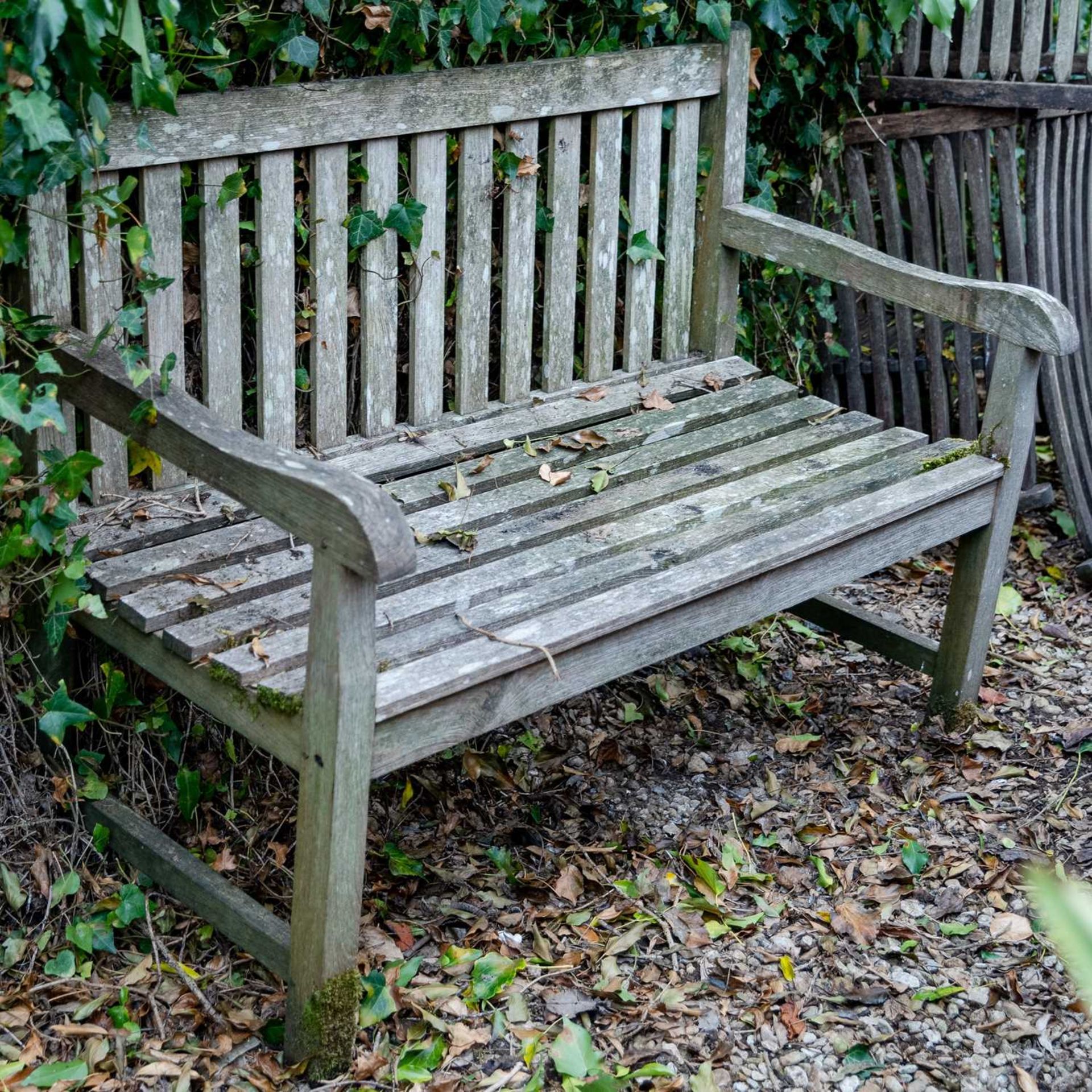 An old teak garden bench, 120cm wide x 86cm highWeathered condition.