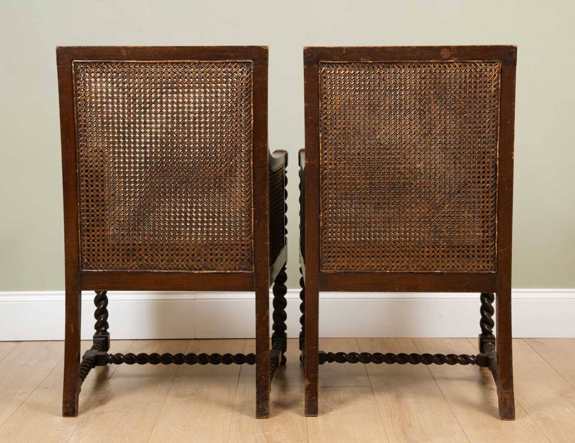 A pair of early 20th century oak framed Bergere armchairs with double caned backs and sides and with - Image 4 of 4