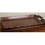 A Georgian-style rectangular mahogany tray with pierced carrying handles to either side, 53cm wide x