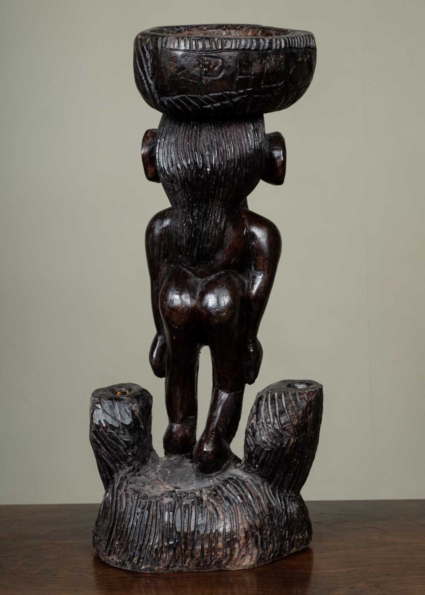 A 20th century tribal stand or stool with carved decoration of a nude female and indistinct - Image 2 of 2
