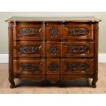 A 19th century French walnut three drawer commode with cast handles and escutcheons, and all