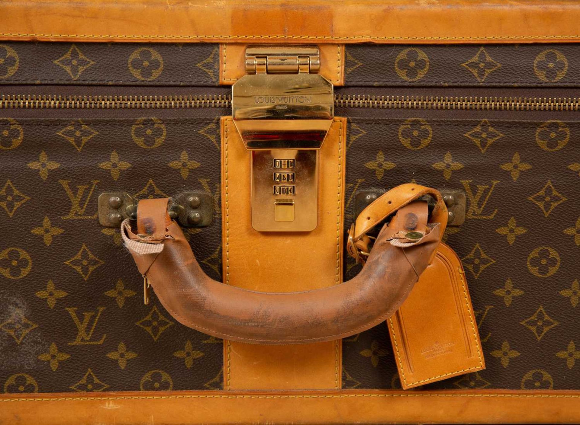 A Vintage Louis Vuitton suitcase with brass clasp and combination lock, 85cm wide x 27cm deep x 54cm - Image 3 of 8