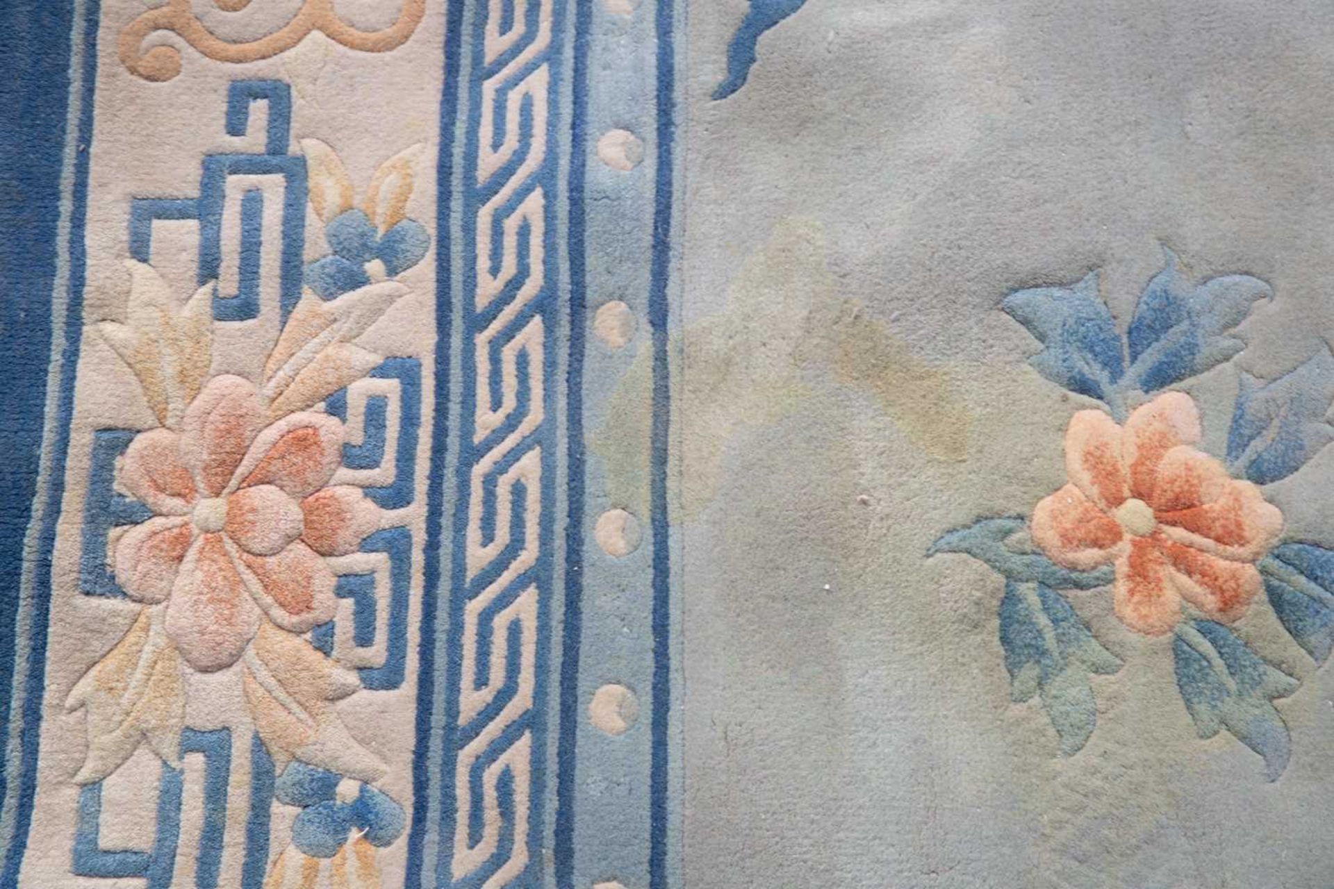 A Chinese light blue ground carpet with floral decoration and blue border, 314cm x 244cmStains, - Image 5 of 7