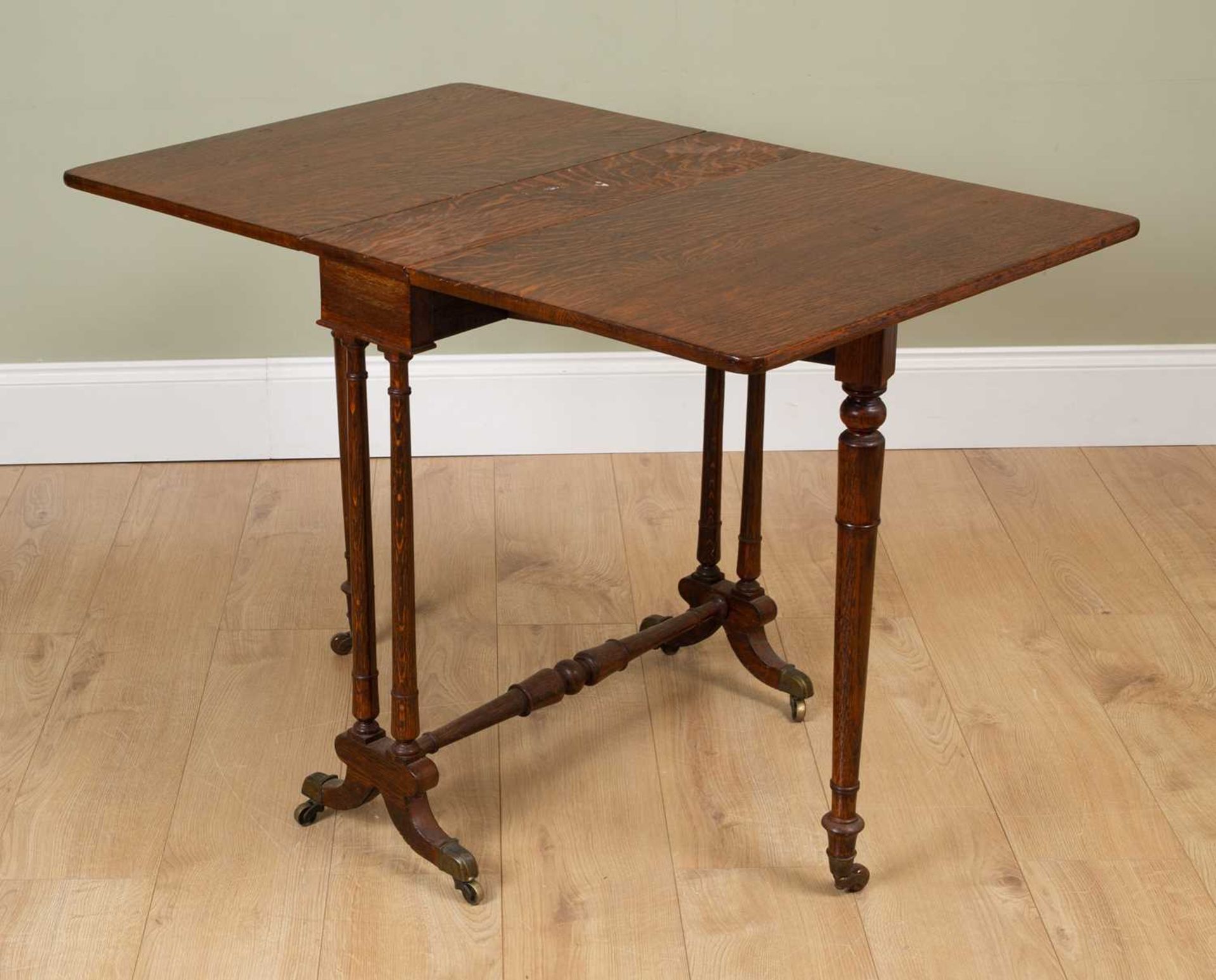 A Victorian oak Sutherland table with turned tapering legs and turned supports terminating in - Image 3 of 4